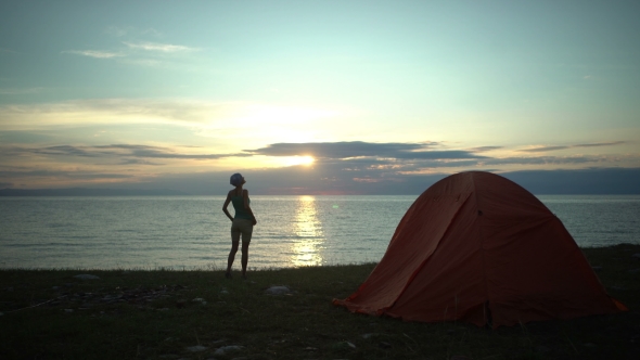 Woman at Camping Looking at Sunrise in the Morning
