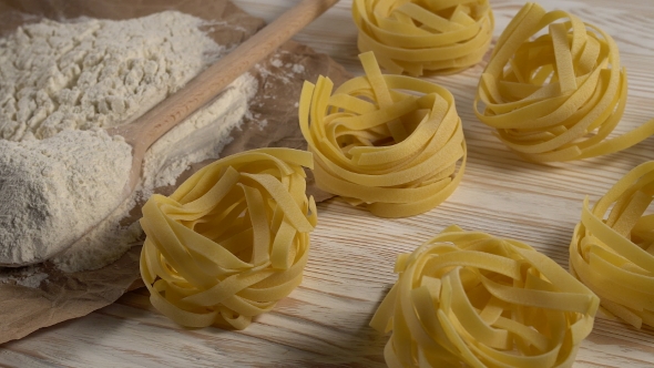 Pasta, Eggs and Flour on Wooden Background