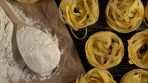 Pasta, Eggs and Flour on Wooden Background