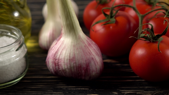 Pasta, Oil, Tomatos and Garlic on Wooden Background