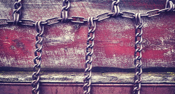 Vintage stylized chains on old wooden wall. Stock Photo by Maciejbledowski
