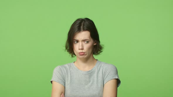 Slowmotion Cute Upset Sulking Girlfriend Cross Arms Over Chest Defensive Pouting and Look Around alt