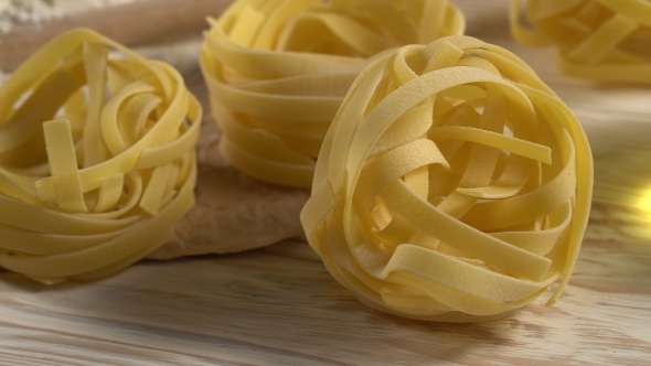 Pasta, Oil and Flour on Wooden Background