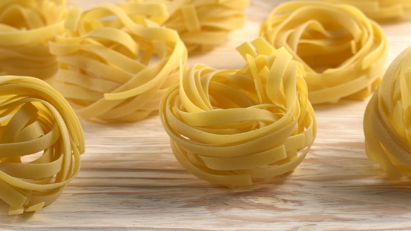 Pasta, Oil, Tomatos and Garlic on Wooden Background