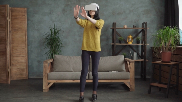 Woman Is Using a Vr Head-mounted Display alt