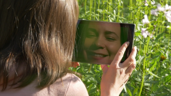 Tablet Reflecting Smiling Female Face