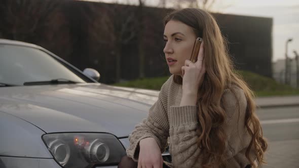 Young Upset Woman Making Phone Call After Traffic Accident alt