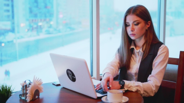 One Business Woman Working with Laptop in Cafe