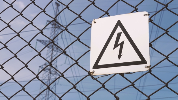 Power Substation. Warning Sign About the Risk of Electric Shock. High-voltage Wires on the Support alt