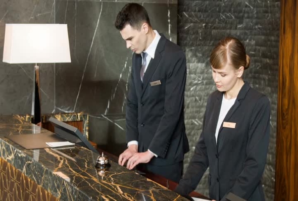 Smiling Concierges Enetering Guest Data alt