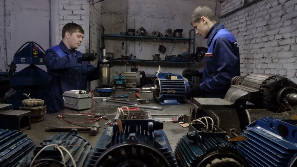 Two Workers Repair the Electric Motors. Repair of Industrial Electric Motor.