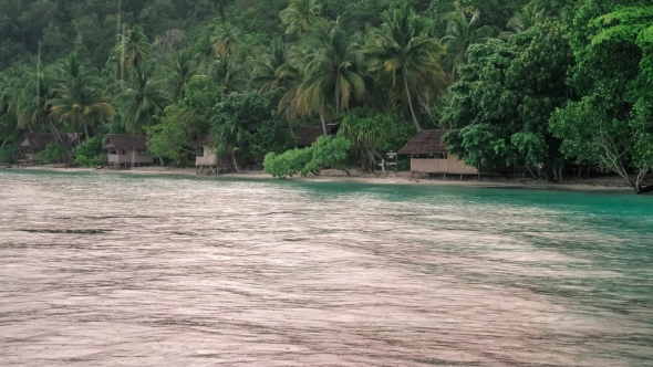 Tropical Rain Over the Bamboo Homestay Huts on the Beach, Gam Island, Raja Ampat, West Papua