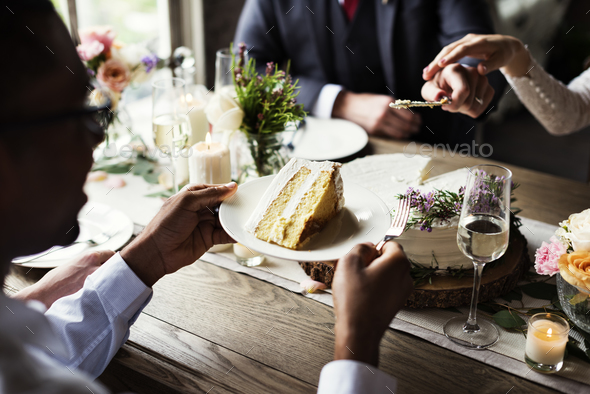 Bride and Groom Cutting Cake on Wedding Reception - Stock Photo - Images