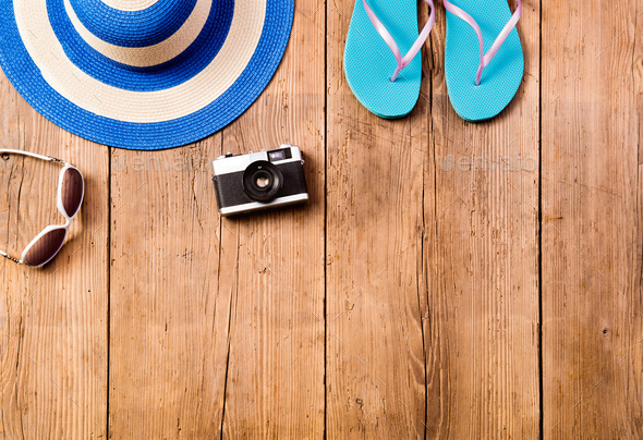 Summer vacation composition. Sunglasses, camera, hat, flip flops