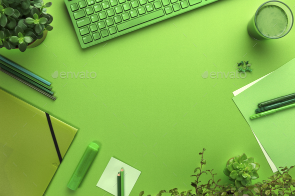 Environmental concept of a green office desk with supplies - Stock Photo - Images
