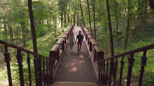 Pair Adult People Holding Hands, Mount Up the Stairs alt
