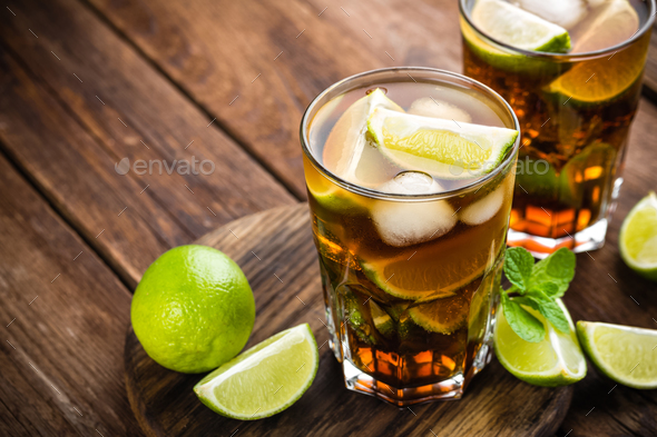 Cuba Libre cocktail with cola, lime and ice in glass, cold longdrink - Stock Photo - Images