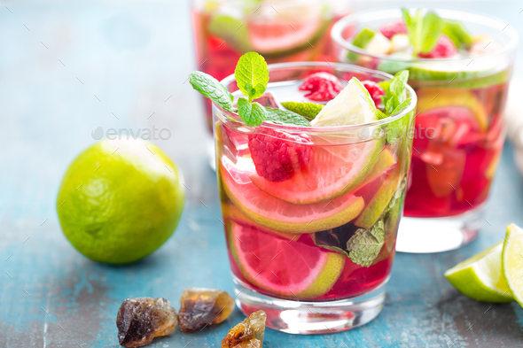 Refreshing mint cocktail mojito with rum, lime and raspberry, cold drink or beverage - Stock Photo - Images
