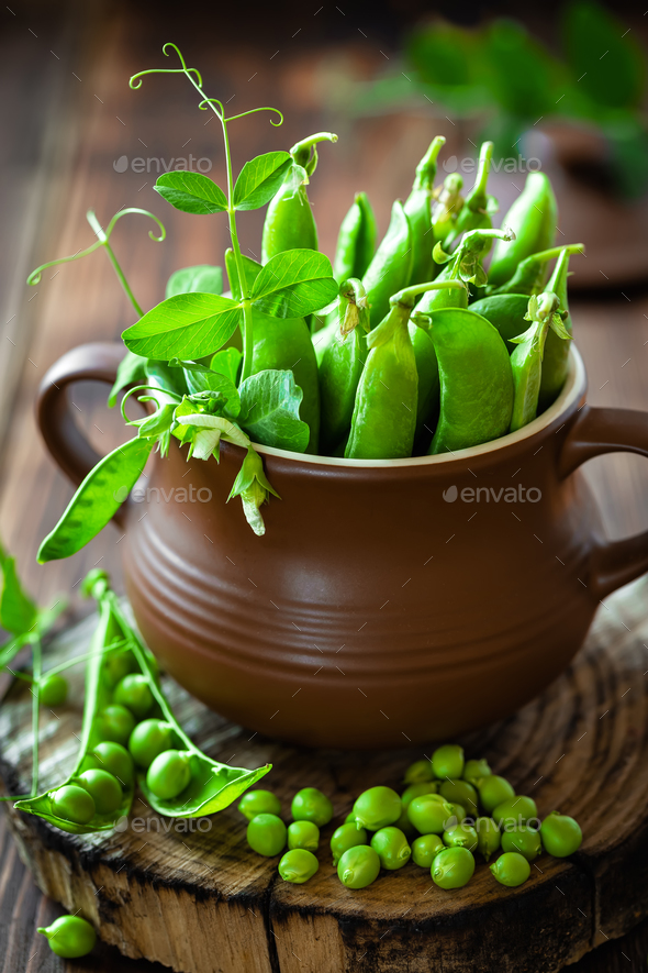 Fresh green peas on dark wooden rustic background - Stock Photo - Images