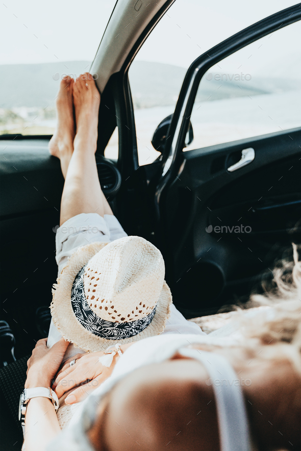 Girl having a rest in a car - Stock Photo - Images