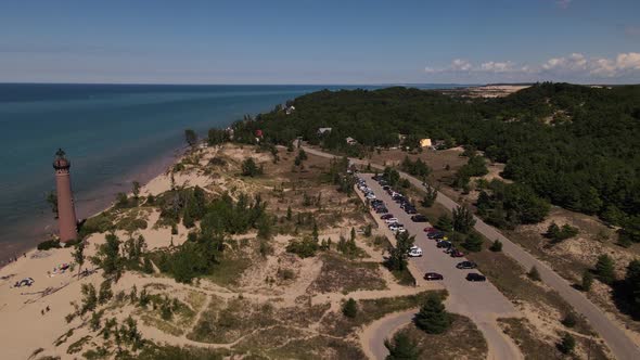 4k drone video of Little Sable Lighthouse in Silver Lake, Michigan in the summer. alt