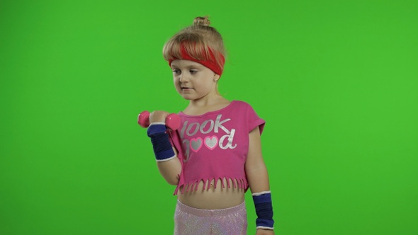 Caucasian Girl in Sportswear Making Exercises with Dumbbells. Workout for Kids. Athletic Child alt
