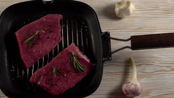 Beef Fillet on a Pan with Pepper, Rosemary and Garlic.