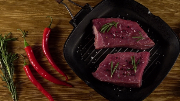 Beef Fillet on a Pan with Pepper, Rosemary and Garlic.