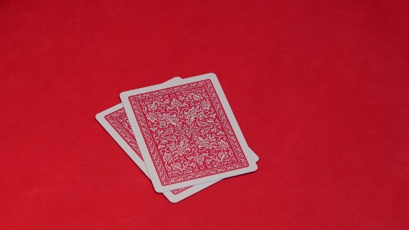 Human Hand Opening Two Cards in Poker Game