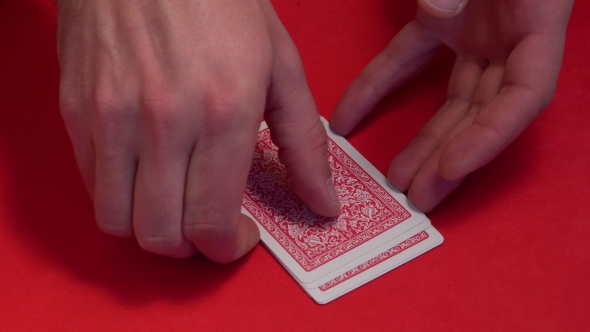 Human Hand Opening Five Cards in Poker Game.