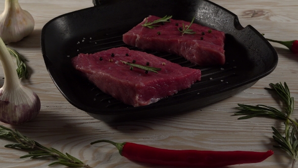 Beef Fillet on a Pan with Pepper, Rosemary and Garlic.