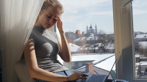 Young Woman Rubs Her Eyes