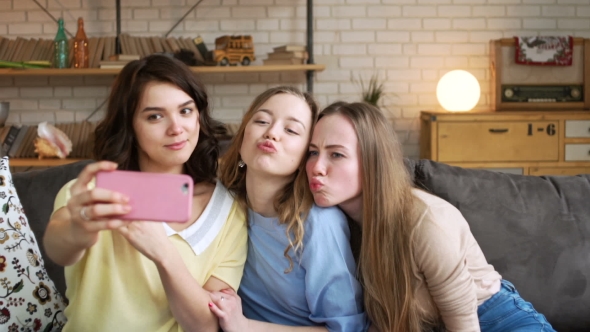 Three Young Female Best Friend Have Fun and Make Selfie on Mobile, Grimacing and Laughing