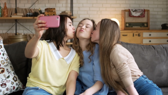 Three Young Female Best Friend Have Fun and Make Selfie on Mobile, Grimacing and Laughing