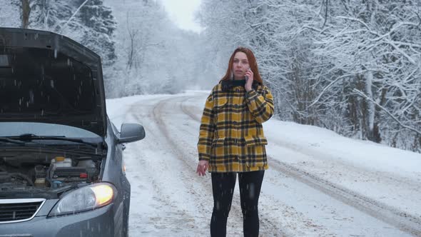 Young Woman Calling Car Assistance Services Standing By Breakdown Automobile on the Roadside