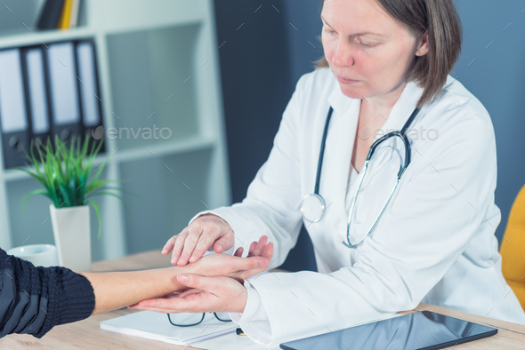 Female patient at orthopedic doctor medical exam for wrist injur - Stock Photo - Images