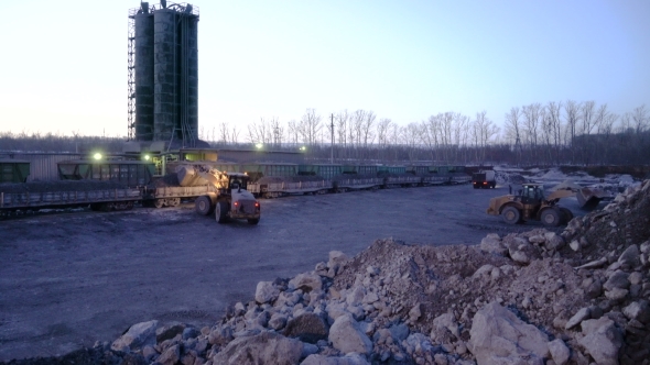 of Ore Storage. Tiltdozers Load Ore Into Gondola Cars.