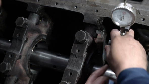 Mechanic Measures the Inner Surface of the Engine Block with a Micrometer. Cylinder Block Bore.