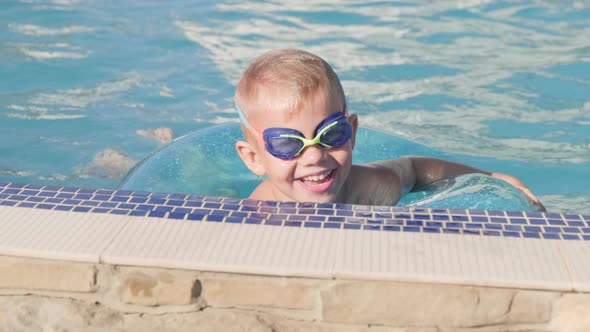 Portrait Smiling Boy in Swimming Pool Child in Swimming Glasses and Swimming Circle alt