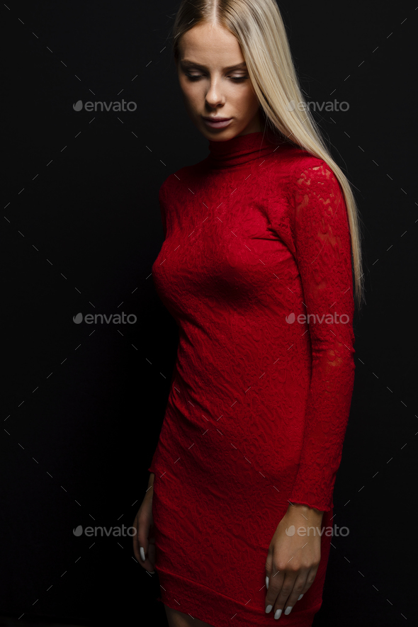 Beautiful Blonde Haired Woman In Red Dress Looking Down Stock