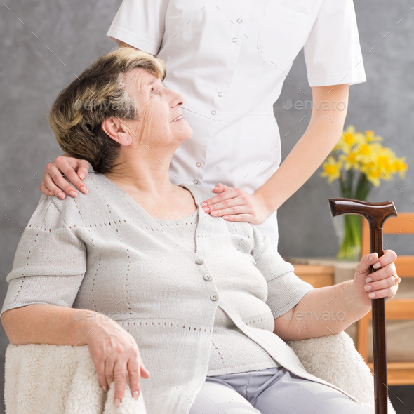 Senior lady needing help from caregiver - Stock Photo - Images