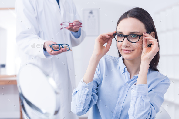 Optician with eyeglasses and client - Stock Photo - Images