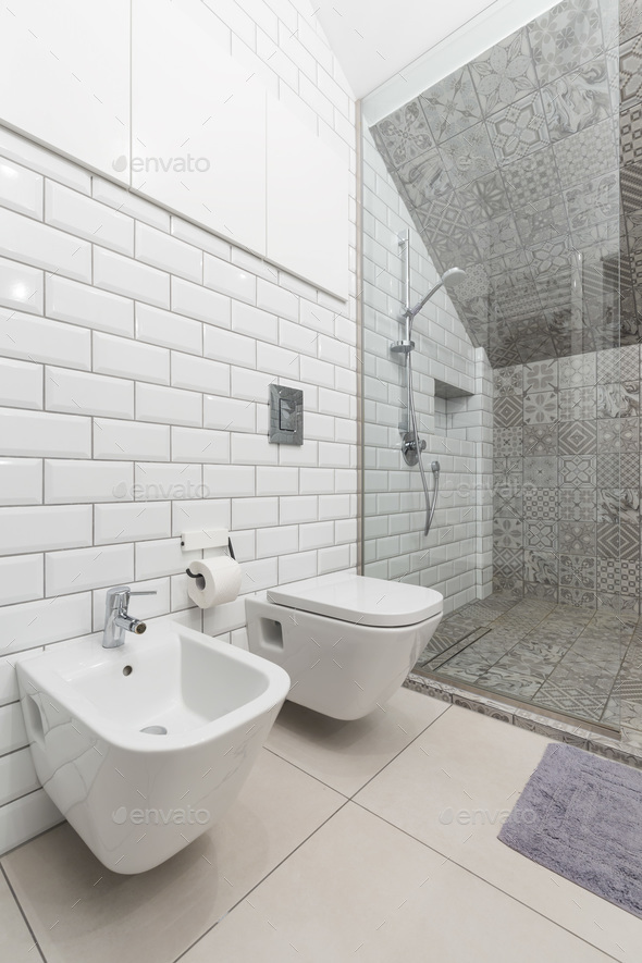 White bathroom with toilet and shower