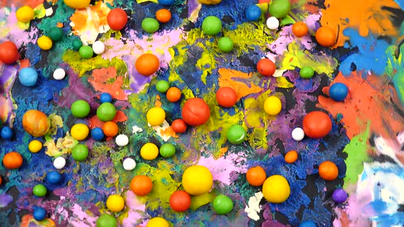 Multi colored plasticine balls and cardboard with plasticine abstract painting rotate on a turntable