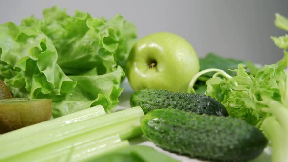 Lots of Green Fruits and Vegetables on a White Table