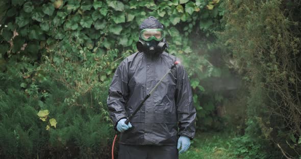 Man in Chemical Protection Suit is Using Pulivelizer to Spraying Chemical Mix