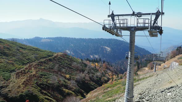 ROSA-KHUTOR, RUSSIA - October 13, 2018. Moving Cabins of the Cable Road. Funicular Moving Over Trees alt