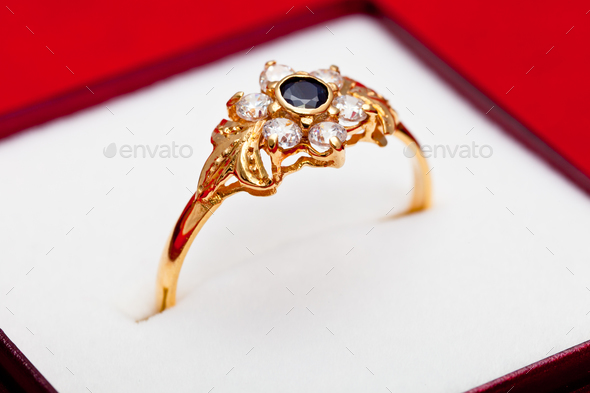 Gold ring with white and blue zirconia enchased - Stock Photo - Images