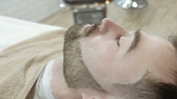 VideoHive Portrait of Handsome Young Man Getting Beard Shaving with Straight Razor Focus on the Blade 19919239 VideoHive Portrait of Handsome Young Man Getting Beard Shaving with Straight Razor Focus on the Blade 19919239