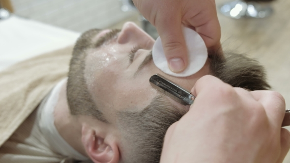 VideoHive Portrait of Handsome Young Man Getting Beard Shaving with Straight Razor Focus on the Blade 19919247 VideoHive Portrait of Handsome Young Man Getting Beard Shaving with Straight Razor Focus on the Blade 19919247